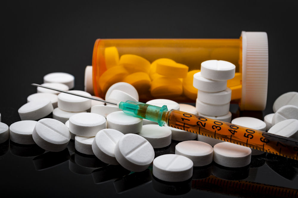 opioids, prescription pills, and heroin syringe