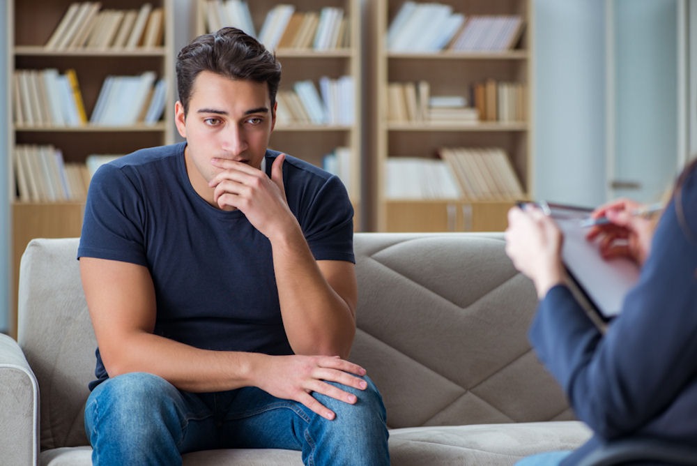 Man discussing sobriety and relapse with therapist